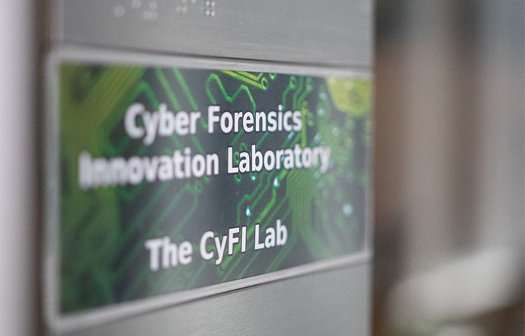 A sign outside of a room that reads  Cyber Forensics Innovation Laboratory 