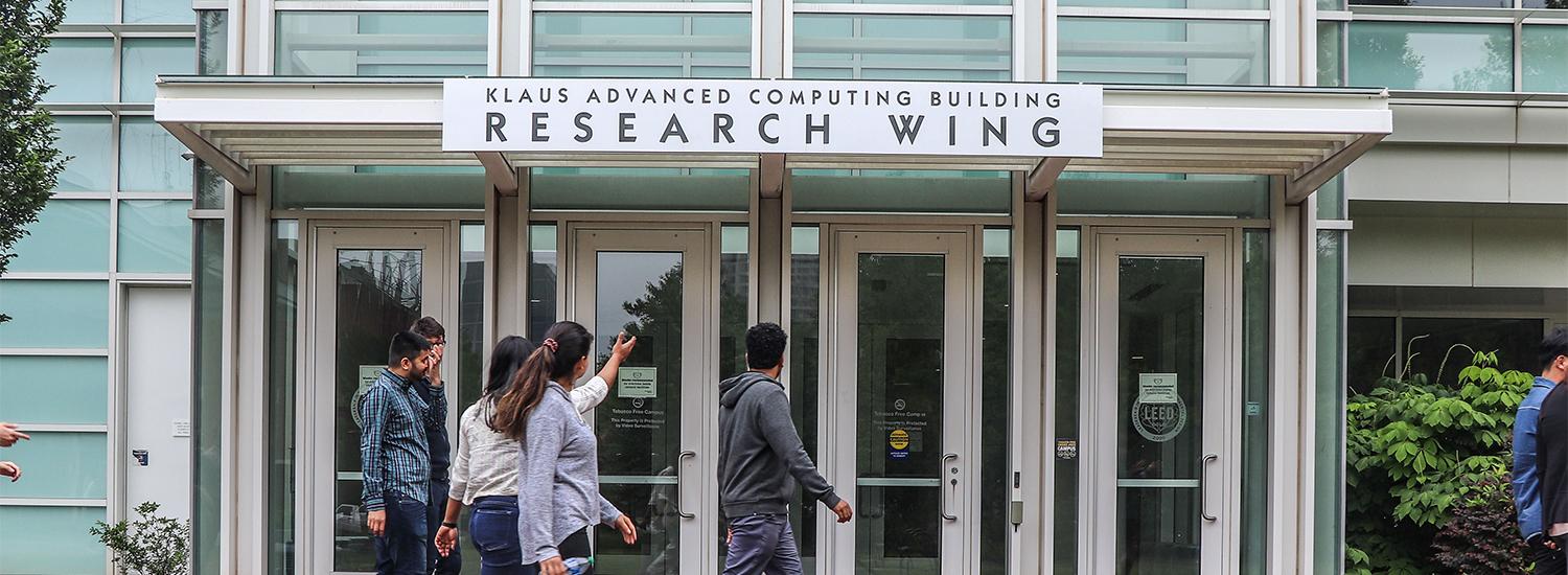 People walking in front of building