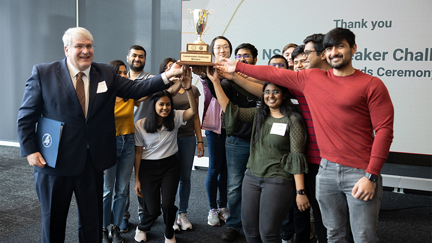 group of people with a trophy