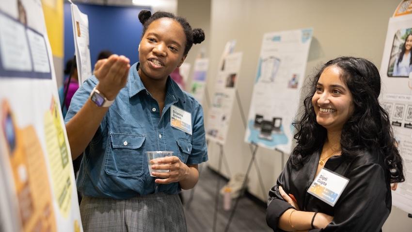 Two women discussing research 