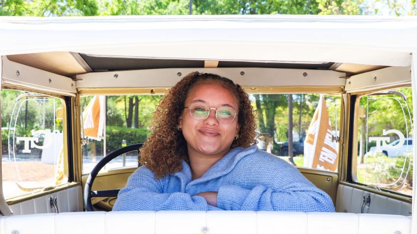 woman sitting in the back of the Ramblin Wreck