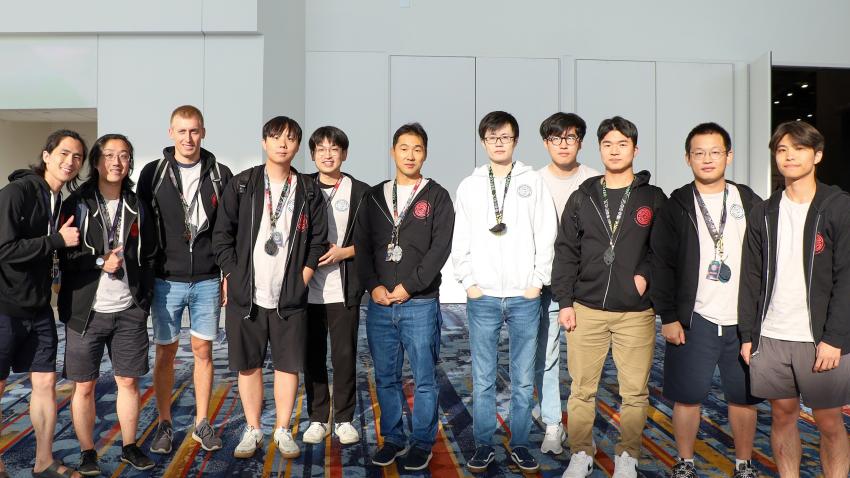 A group photo of people standing in a convention hall