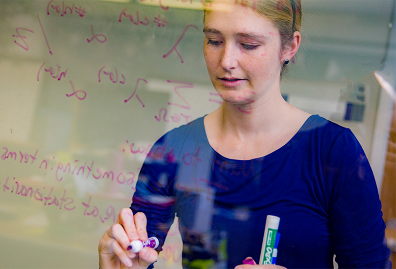 woman writing on glass