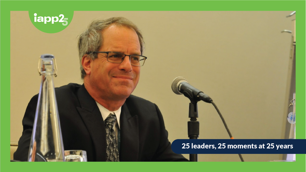 A graphic image showing Peter Swire, wearing a suit, sitting in front of a microphone.